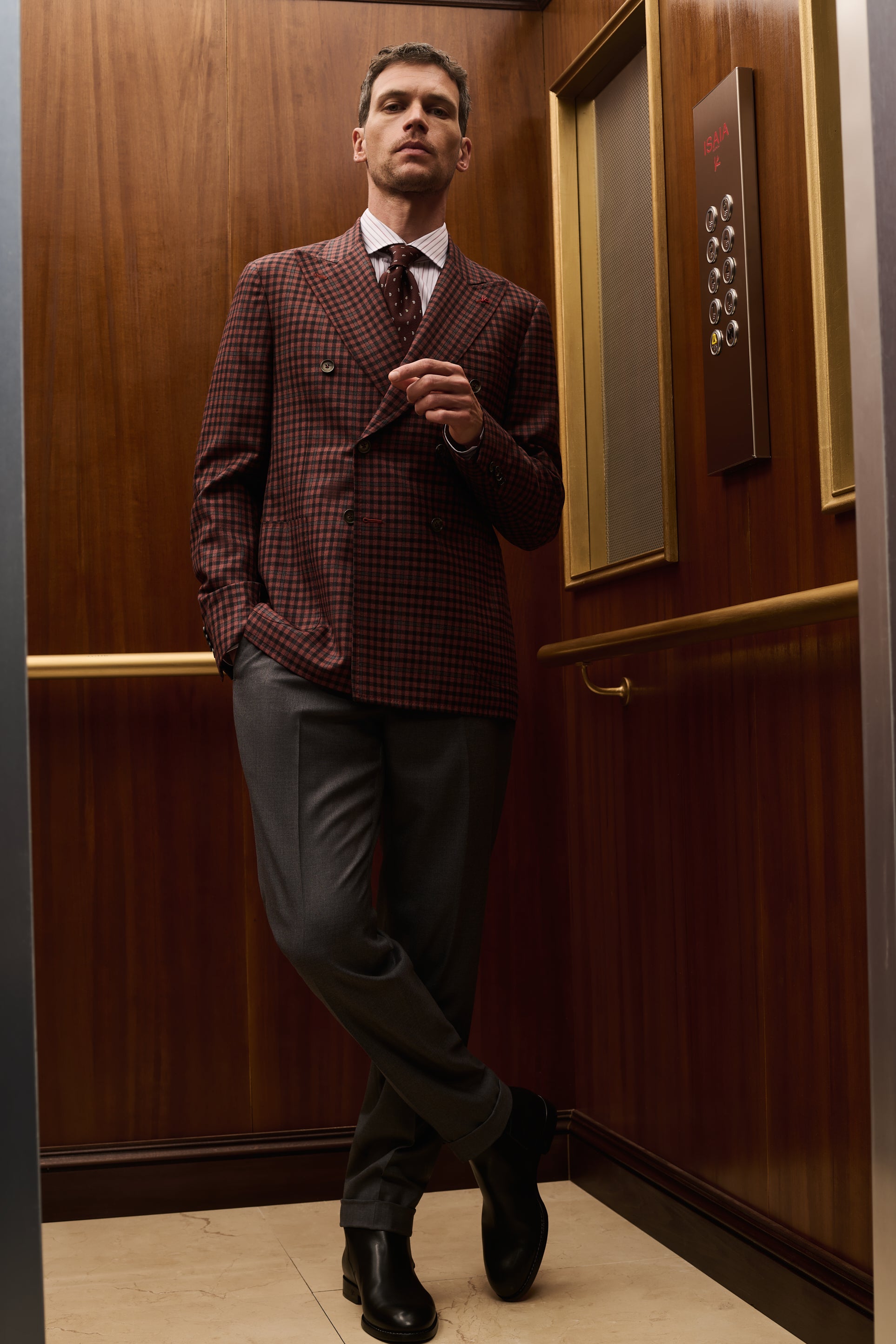 ISAIA Made to Measure: burgundy check double-breasted jacket with grey trousers, legs crossed