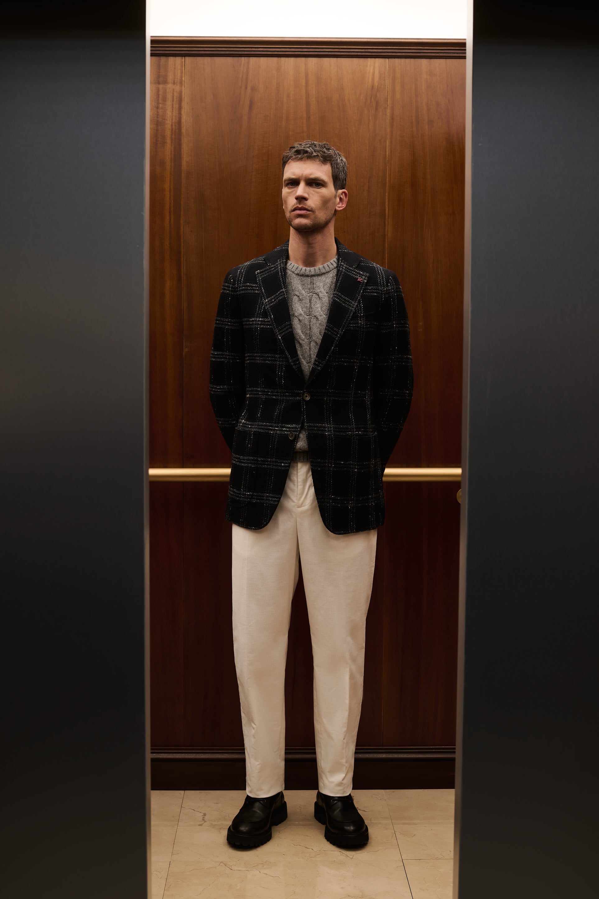 ISAIA Made to Measure: dark green tartan jacket with grey cable-knit sweater and white trousers